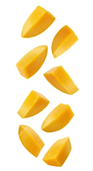 Mango fruit pieces tumbling down, white background. Sweet mango slices falling gracefully, symbolizing organic and fresh produce photo