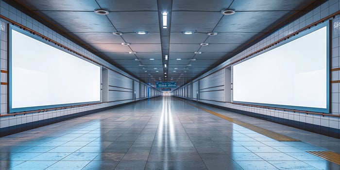 A modern subway corridor featuring empty advertising spaces and sleek architectural design. photo