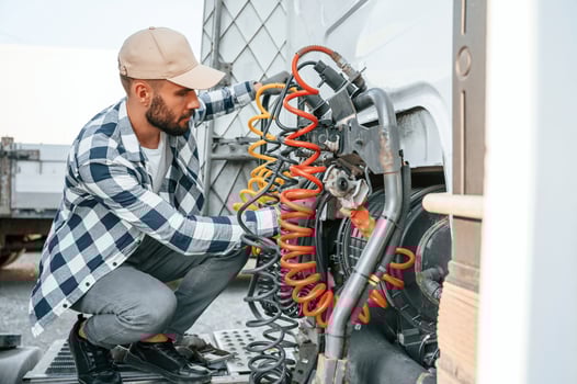 Checking the wires connection.. Young truck driver, is with his vehicle at daytime photo