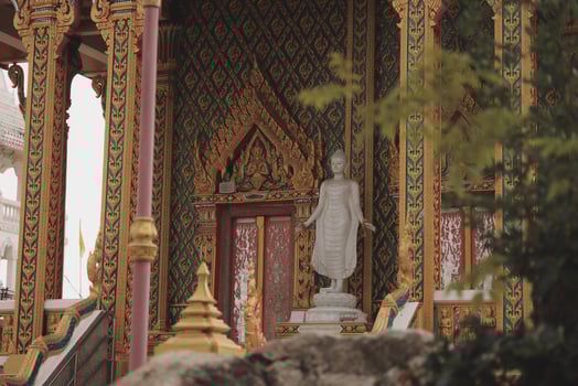 A beautiful Buddha statue in an ornate temple radiates tranquility, inviting reflection photo