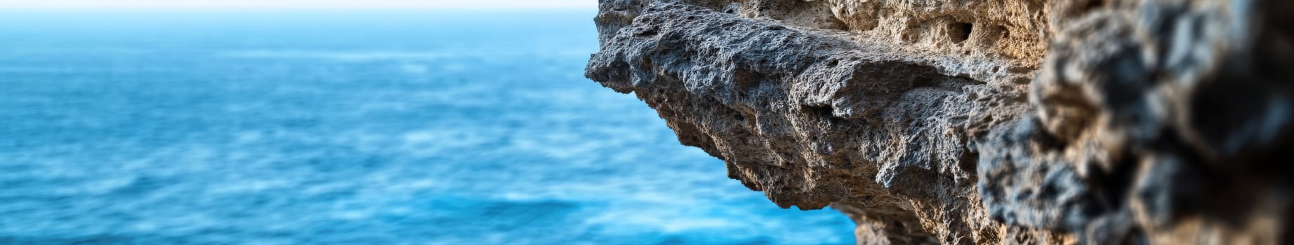 A person is standing on the edge of a cliff photo