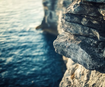 A person standing on the edge of a cliff photo