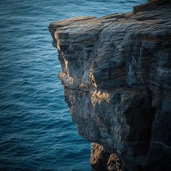 Rugged cliff edge above ocean photo