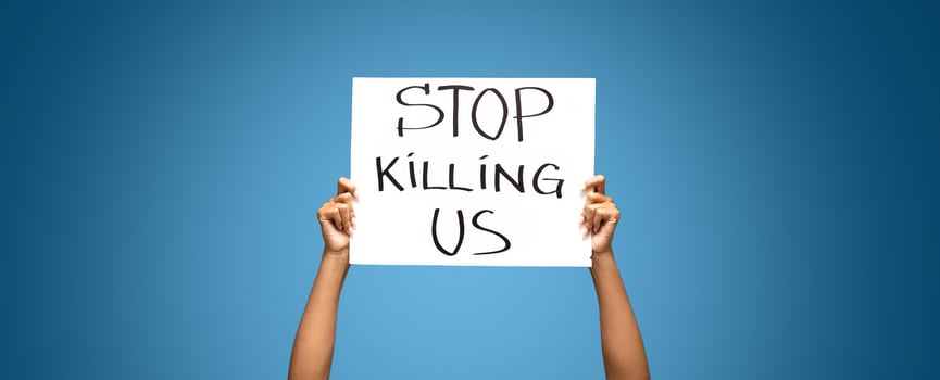 Black Lives Matter. African american woman standing with protest banner Stop Killing Us photo