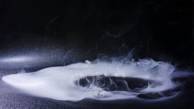 Dense white smoke or fog isolated on black background photo