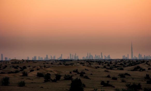 The skyline of dubai at sunset photo