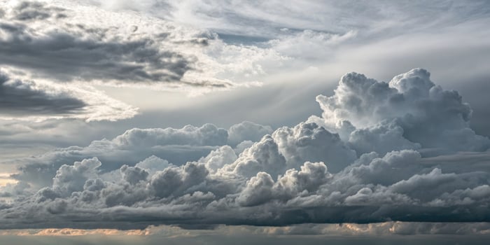 The sky filled with stunning cumulus clouds creates a dramatic scene of nature's beauty after a storm. photo