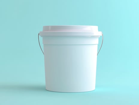 White plastic bucket on a solid light blue background photo