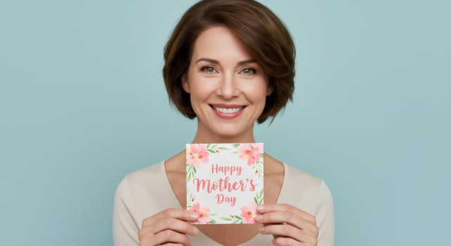 Happy woman proudly holding a Mother's Day card, radiating love and warmth in celebration of women and mothers everywhere photo