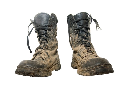 Dirty boots over white photo