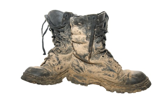 Dirty boots isolated over white photo