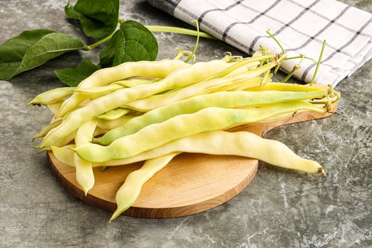 A bunch of beans on a wooden cutting board photo