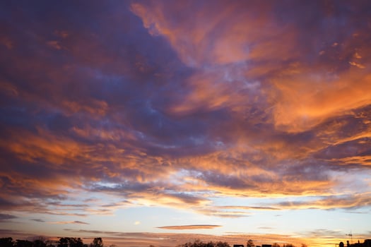 Fiery orange sunset sky with orange and red clouds near the sea. Beautiful sky. photo