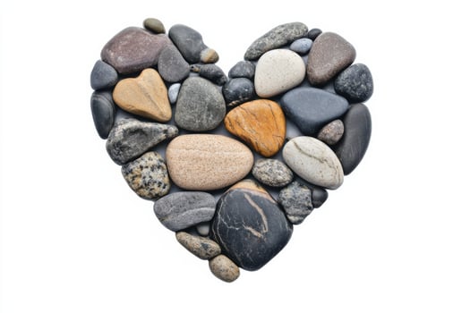 Heart shaped design created with various beach stones on a clean white background for a picturesque Valentines Day decor photo