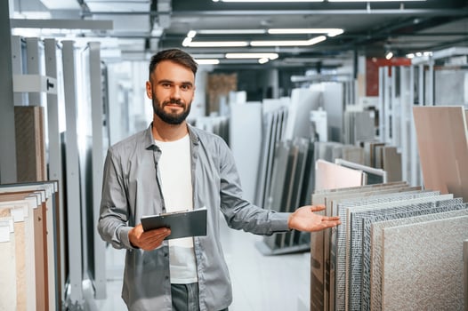Manager with notepad. Stylish beautiul man is in the store of goods for the home. photo