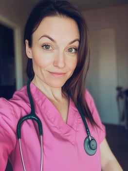 Confident nurse smiling and taking a selfie at hospital photo