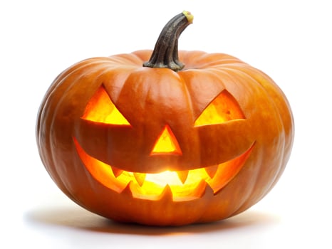 Halloween Pumpkin with Carved Face and Glowing Eyes on White Background photo
