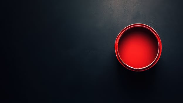 A red bowl on a black surface photo