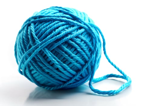 Vibrant Turquoise Yarn Ball with Unraveling Strand on White Background photo