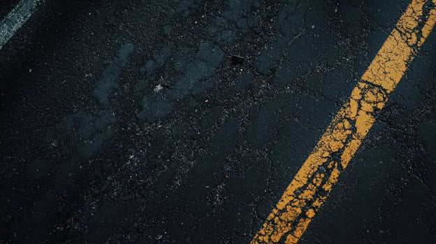 Weathered Asphalt Road Showing Yellow Line Paint photo