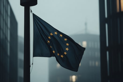 European Union flag waving in foggy urban landscape. photo