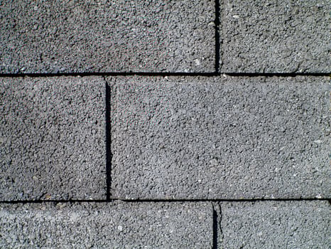A gray brick wall with a black line in the middle photo