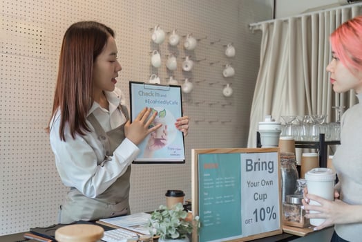 Eco-Friendly Awareness and Barista Education. A barista presenting an eco-friendly initiative to promote sustainable coffee choices. photo