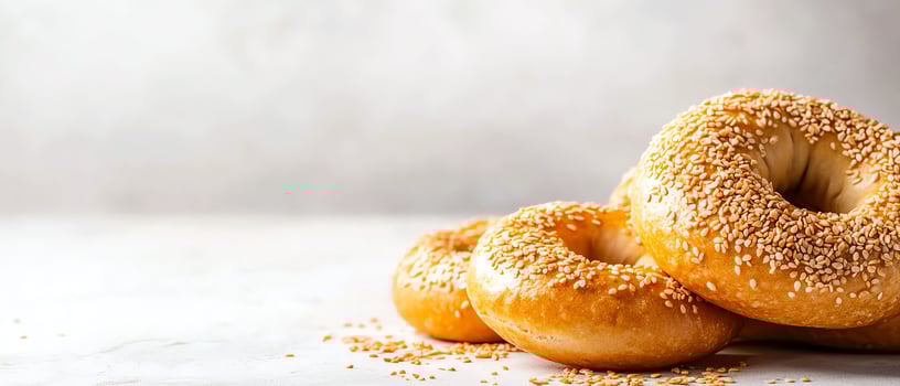 Freshly baked sesame bagels on a table. photo