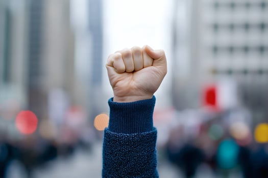 Fist raised in solidarity during city protest for change. photo