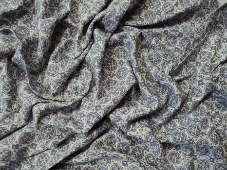 a close up of a purple and white paisley fabric photo