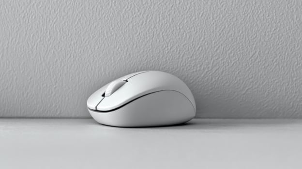 Simple white wireless mouse on a neutral surface, computer accessory photo