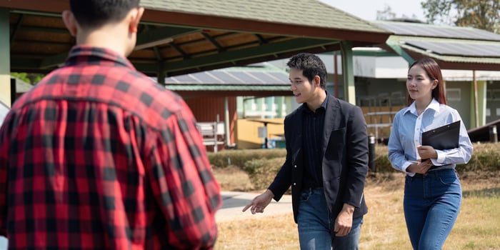 Collaboration and Sustainability. Three professionals discussing renewable energy solutions at an eco-friendly facility. photo