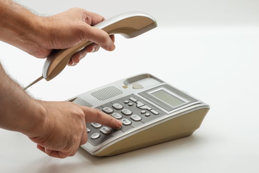 Dialing a phone number on a modern landline telephone photo