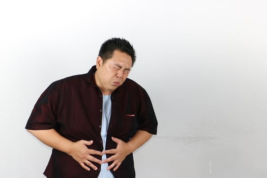 Man with very bad Stomach Ache, hand holding stomatch photo