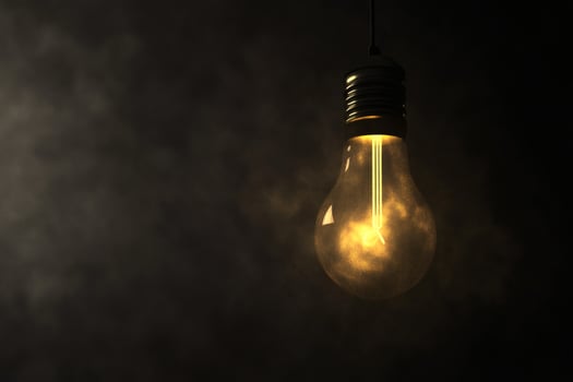 Mysterious glow from a vintage light bulb in darkness. photo