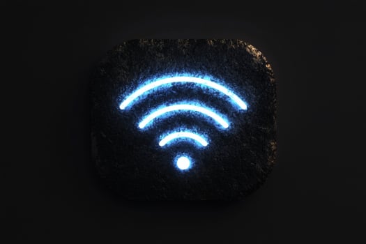 Glowing creative wireless symbol on a textured black background. photo