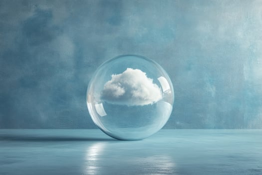 Unique glass orb captures a fluffy cloud against a serene blue backdrop. photo
