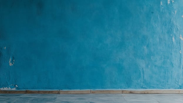 Teal textured wall with worn baseboard photo