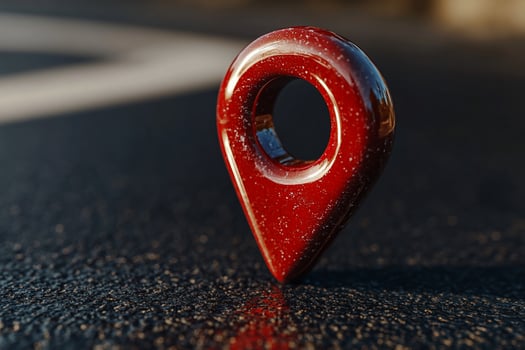 Red location marker on dark surface photo
