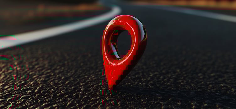 A red pin on the road in front of a car photo