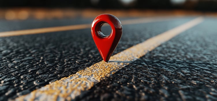Red location pin on asphalt road photo
