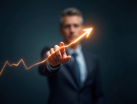 Businessman pointing upward on a graph line photo