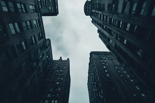 Low angle view of skyscrapers reaching for cloudy sky photo