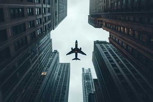 Airplane flying over skyscrapers in a big city photo