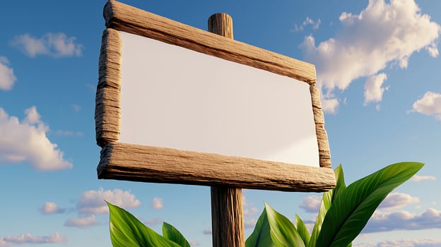 Blank Wooden Signboard Surrounded by Green Leaves Under Blue Sky with Fluffy Clouds photo