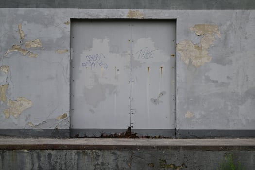 Weathered Gray Wall with Closed Metal Door photo