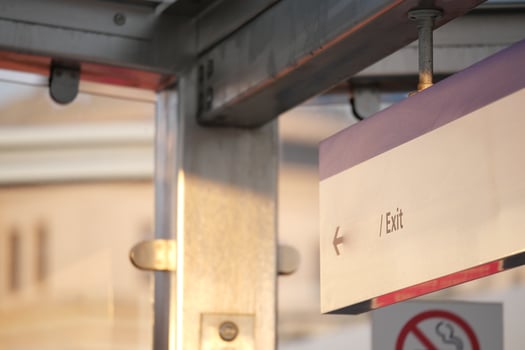 Exit sign in urban transit station during late afternoon light photo