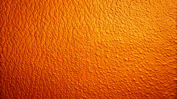 Textured Orange Surface with Rich Color and Detailed Bumps photo