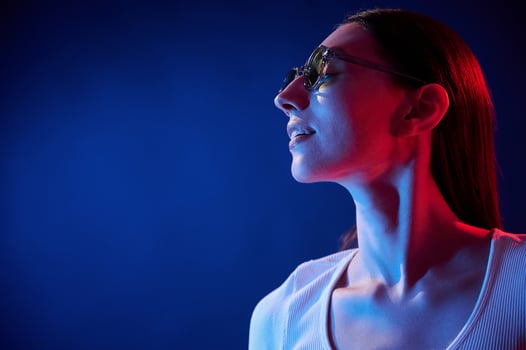 Standing ,and posing. Portrait of young woman ,that is indoors in neon lighting photo