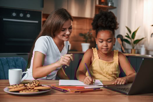 Learning ,how to draw. .Young mother with her daughter is together at apartment photo